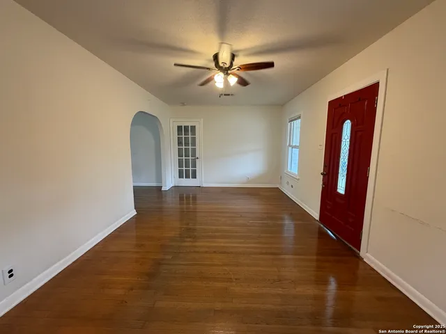 wooden floor in an empty room with a window