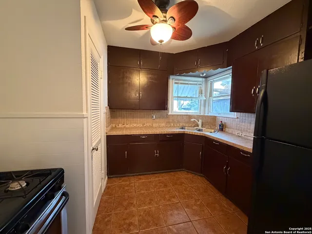 a kitchen with a refrigerator and a sink