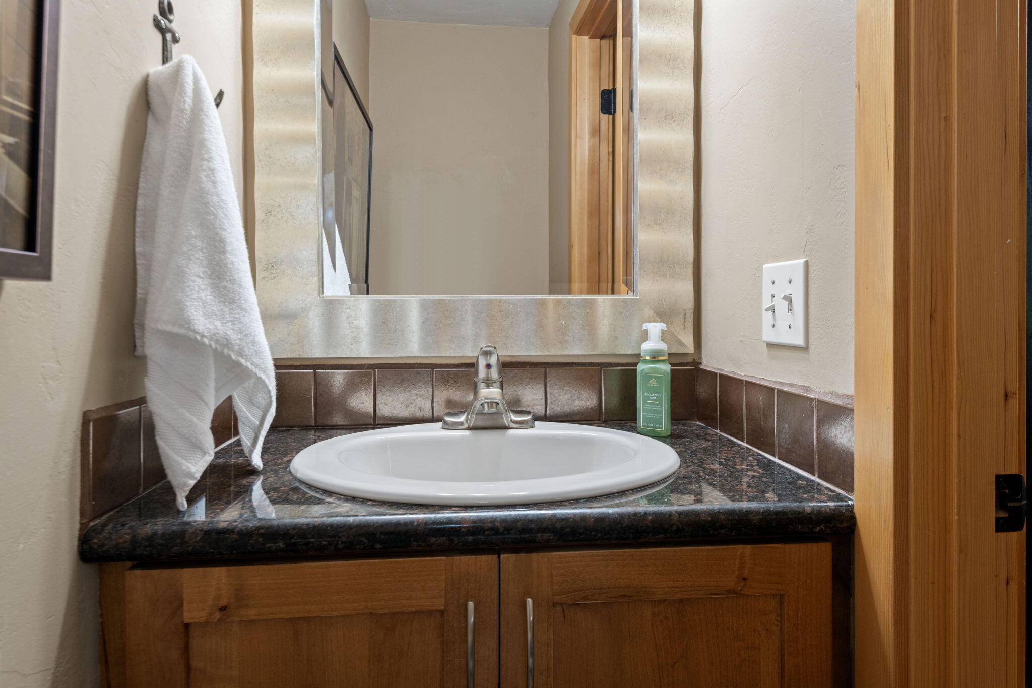 22539 Martee Lane Bend, OR 97701 - Photo 12 of 54 a bathroom with a granite countertop sink and a mirror