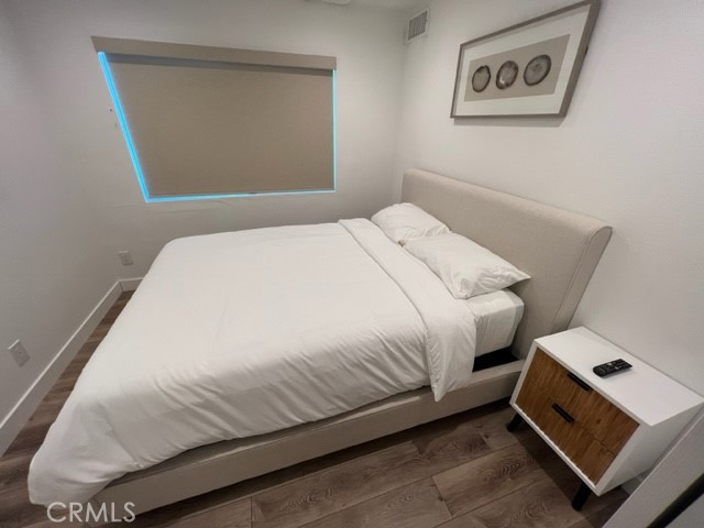 123 36th Street Newport Beach, CA 92663 - Photo 11 of 22 a bedroom with a bed and painting on the wall