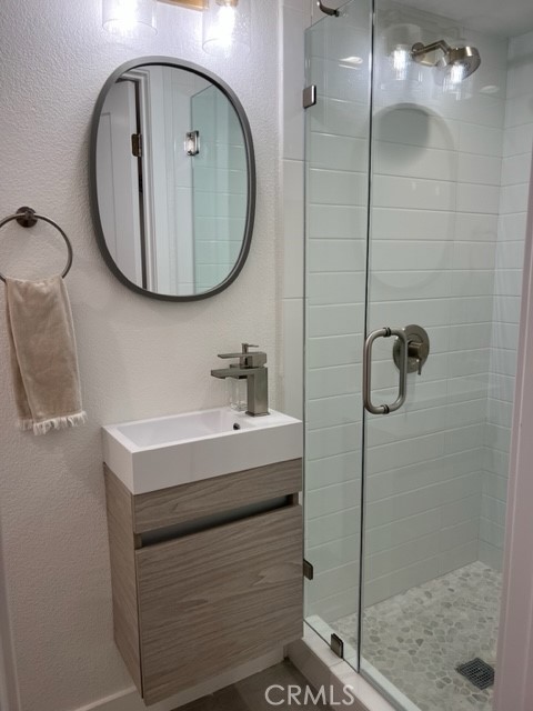 123 36th Street Newport Beach, CA 92663 - Photo 12 of 22 a bathroom with a sink a mirror a vanity and shower