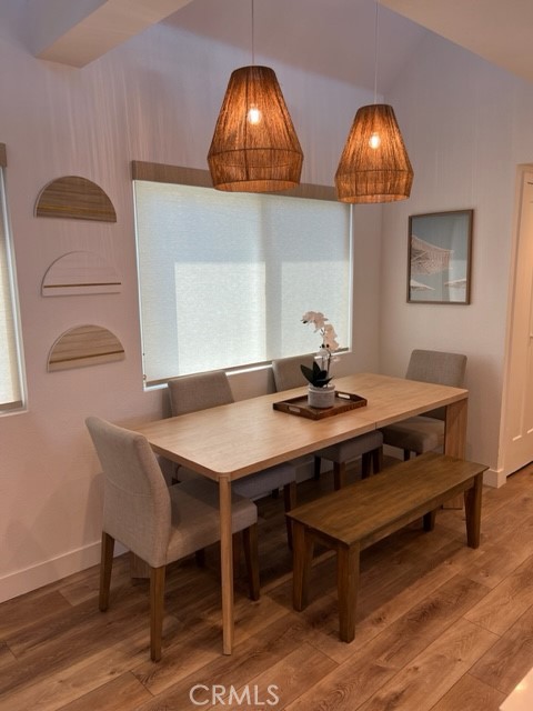 123 36th Street Newport Beach, CA 92663 - Photo 4 of 22 a view of a dining room with furniture and wooden floor