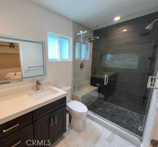 123 36th Street Newport Beach, CA 92663 - Photo 6 of 22 a bathroom with a sink a toilet a mirror and shower