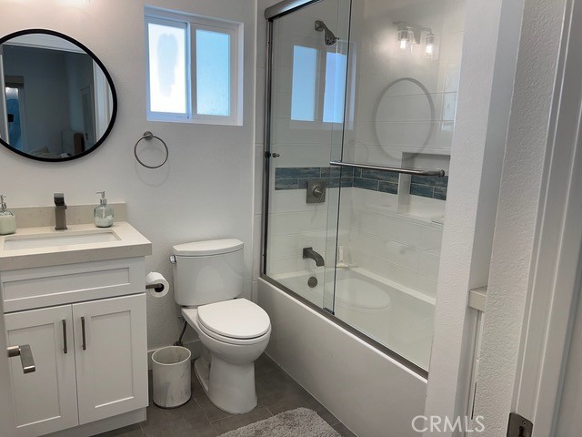 123 36th Street Newport Beach, CA 92663 - Photo 10 of 22 a bathroom with a toilet a sink and a mirror