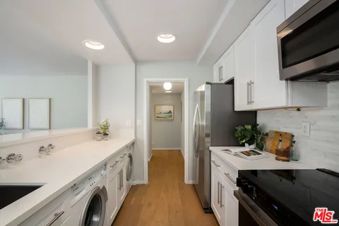 a kitchen with a sink stove and refrigerator