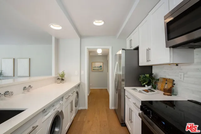 a kitchen with a sink stove and refrigerator