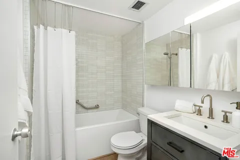 a bathroom with a sink a toilet and a bathtub