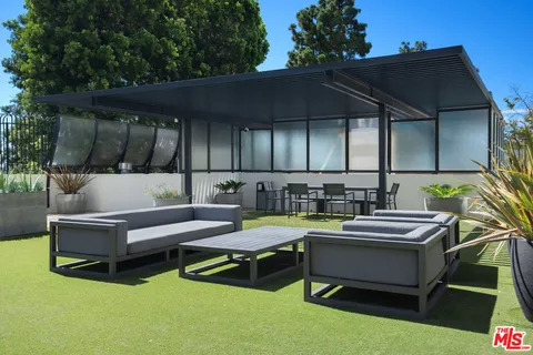 a swimming pool with outdoor seating and yard