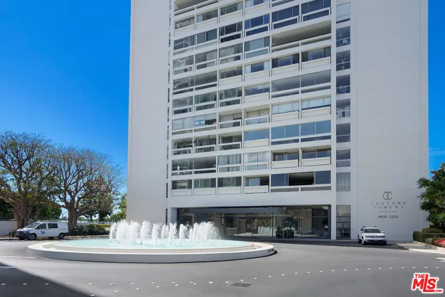 a front view of a building with swimming pool and yard