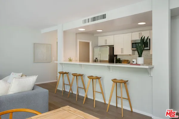 a kitchen with a table chairs sink and cabinets