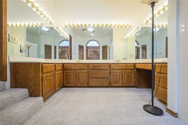a bathroom with a double vanity sink a mirror and a bathtub