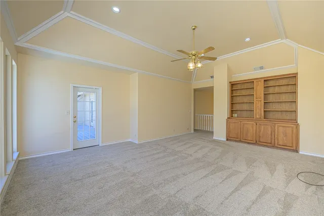 an empty room with closet and ceiling fan