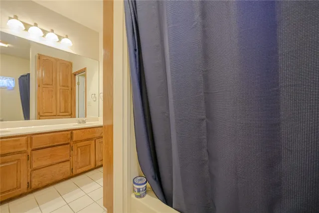 a view of a bathroom with mirror and a sink