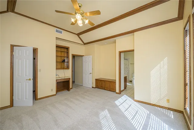 a view of a bedroom with closet and a ceiling fan