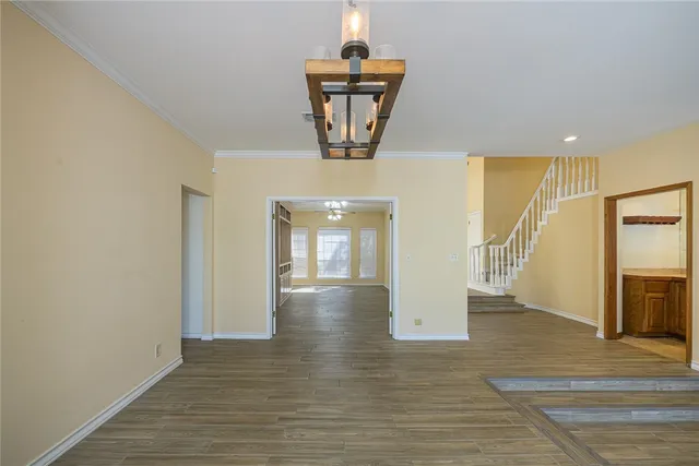 a view of a hallway with wooden floor and staircase