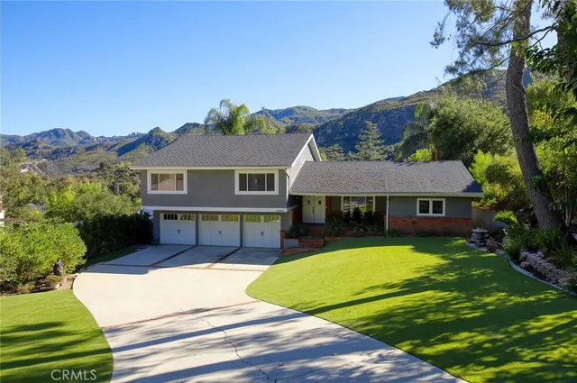 a view of a house with a swimming pool and a yard