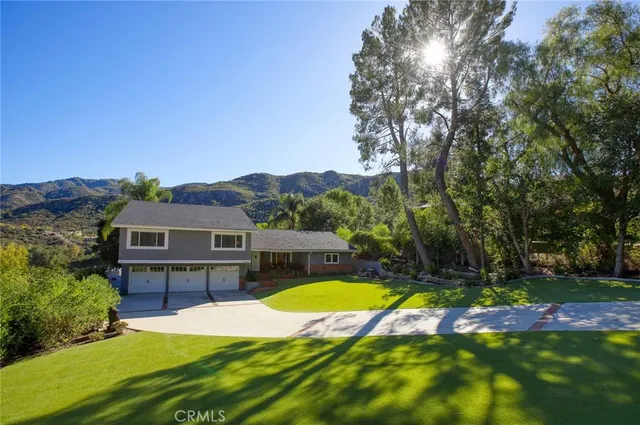 a view of a house with swimming pool and yard