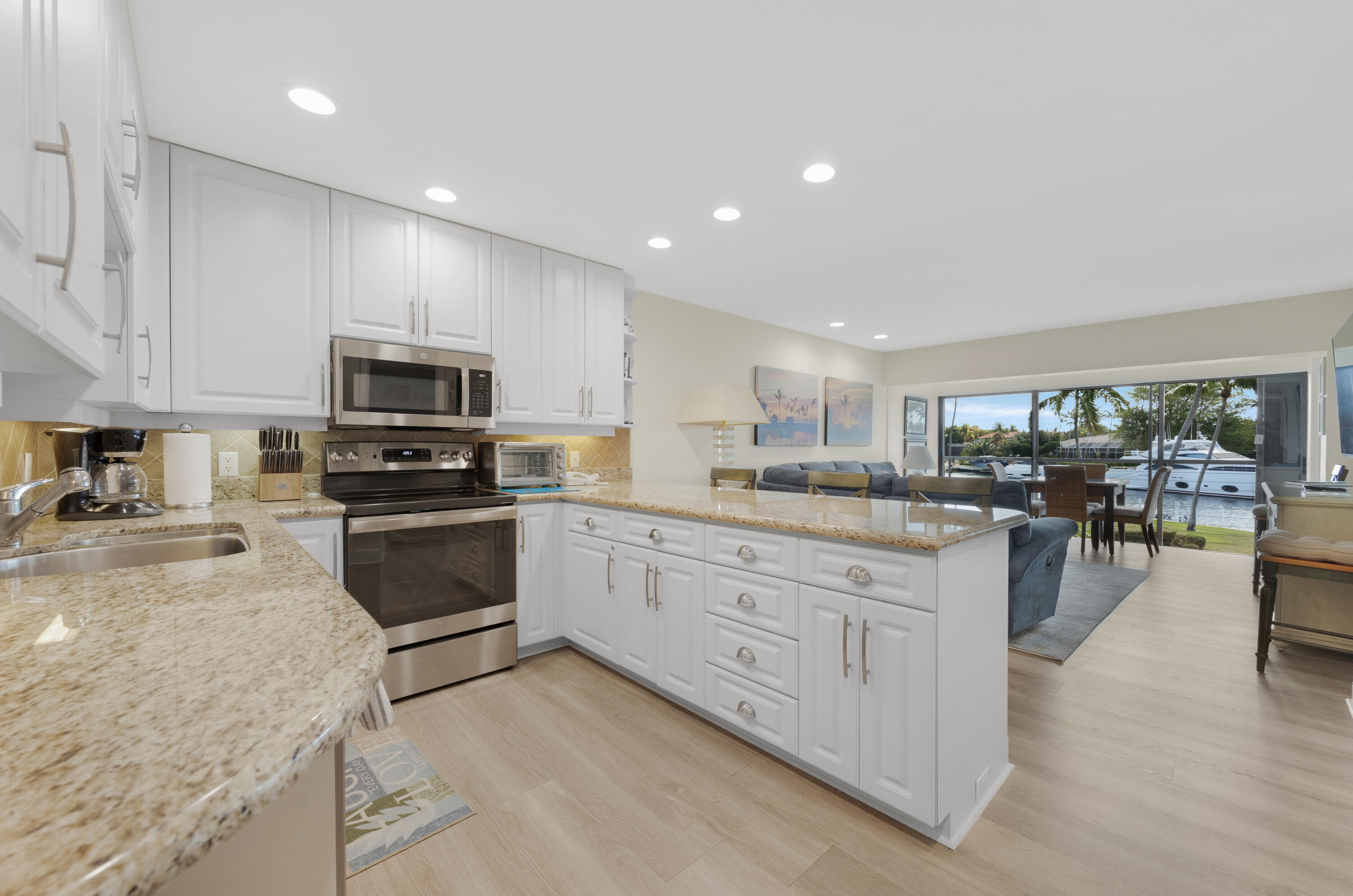 a kitchen with granite countertop lots of counter top space and appliances
