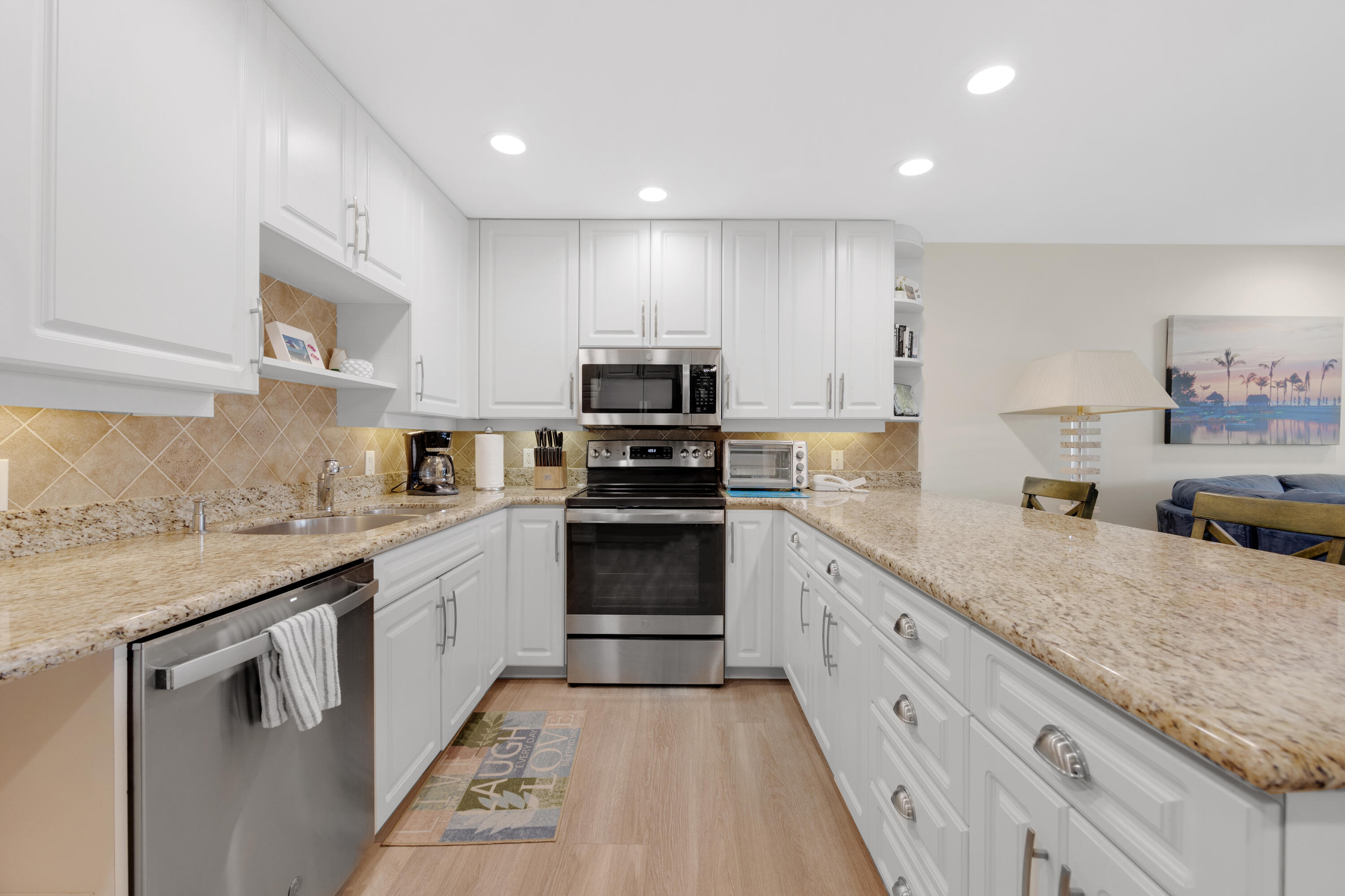 18 Anchor Drive, Unit B Key Largo, FL 33037 - Photo 10 of 17 a kitchen with granite countertop a sink and steel appliances