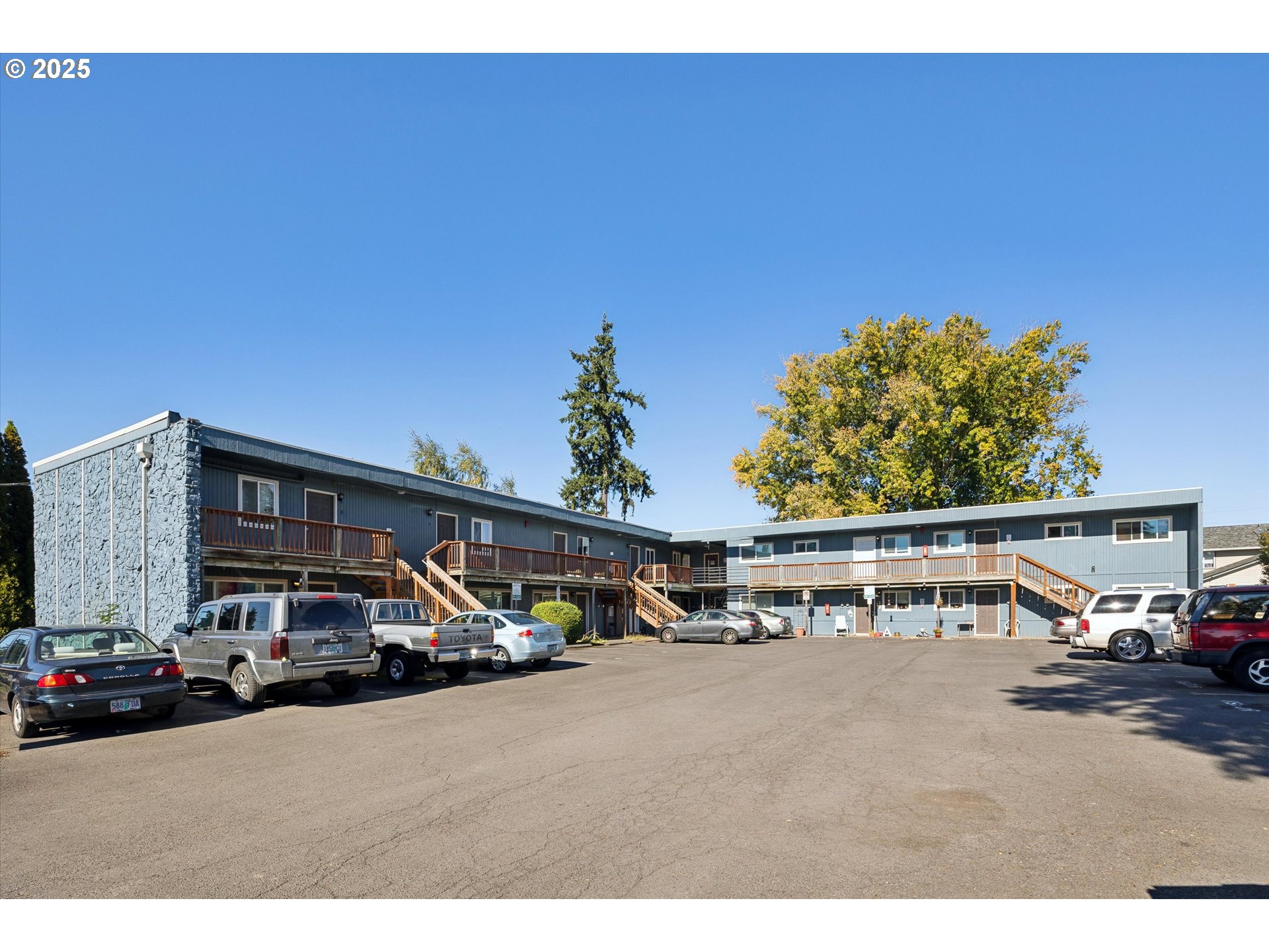 a view of car parked on the side of a street