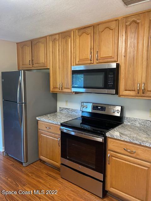4220 James Road Cocoa, FL 32926 - Photo 3 of 34 a kitchen with granite countertop wooden cabinets and a stove top oven