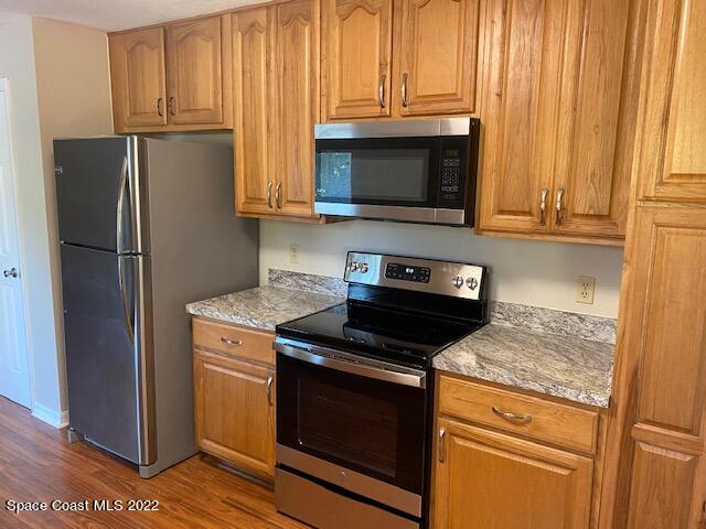 4220 James Road Cocoa, FL 32926 - Photo 4 of 34 a kitchen with granite countertop white cabinets and stainless steel appliances