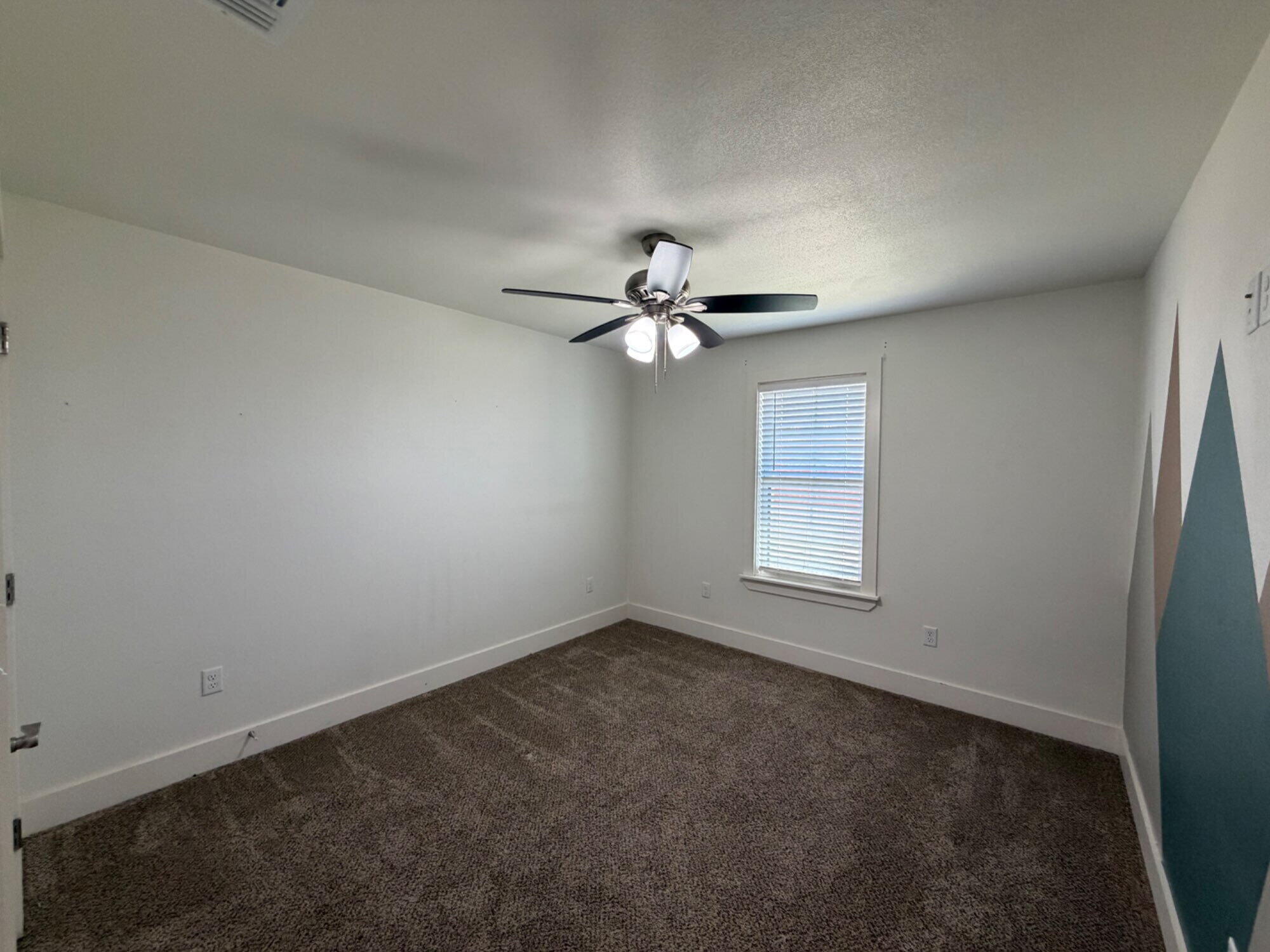 405 Ranger Street Wolfforth, TX 79382 - Photo 18 of 19 an empty room with a window and a fan