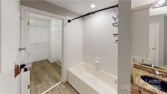 a bathroom with a bathtub and a shower