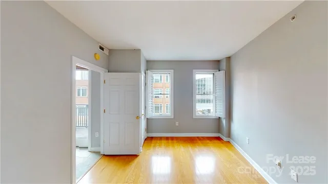 a view of an empty room with a bathtub and windows