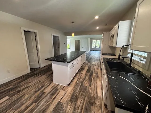 a kitchen with sink cabinets and stove
