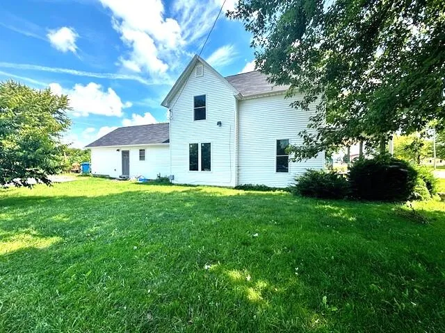 a view of house with backyard