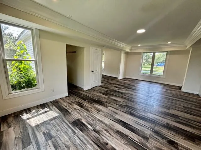 a view of a room with wooden floor