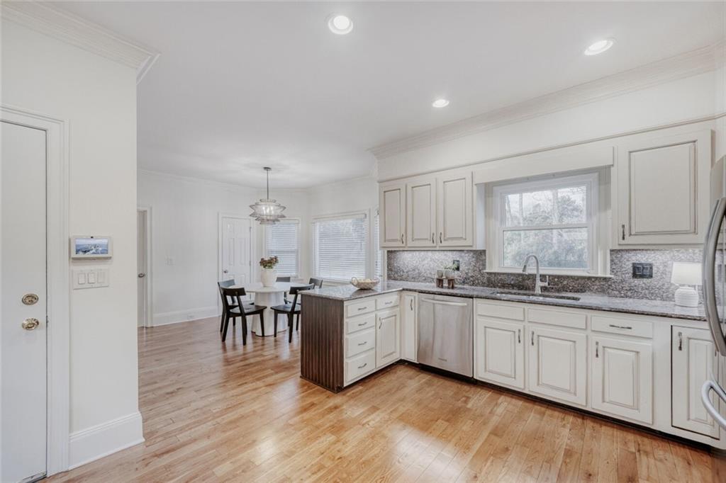 2672 Henderson Ridge Drive Tucker, GA 30084 - Photo 13 of 46 a kitchen with white cabinets sink and dining table chair