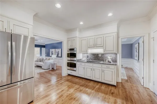a kitchen with white cabinets and stainless steel appliances