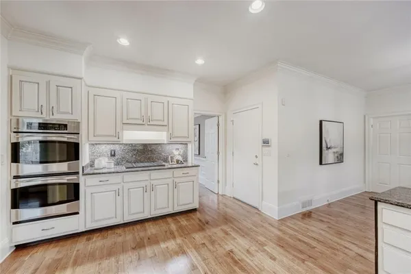 a kitchen with stainless steel appliances granite countertop a stove and a sink
