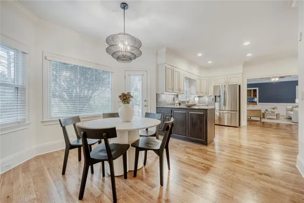 a view of a dining room with furniture and wooden floor