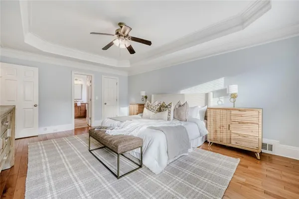 a bedroom with a bed and wooden floor