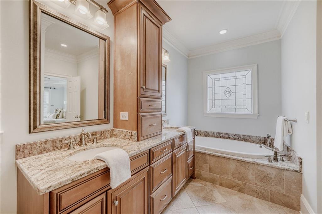 2672 Henderson Ridge Drive Tucker, GA 30084 - Photo 22 of 46 a bathroom with a granite countertop tub sink and mirror