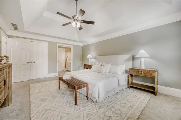 a bedroom with a bed and a ceiling fan