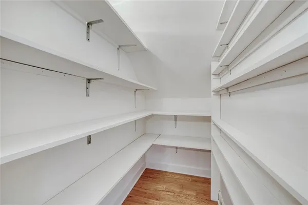 a view of walk in closet with empty racks