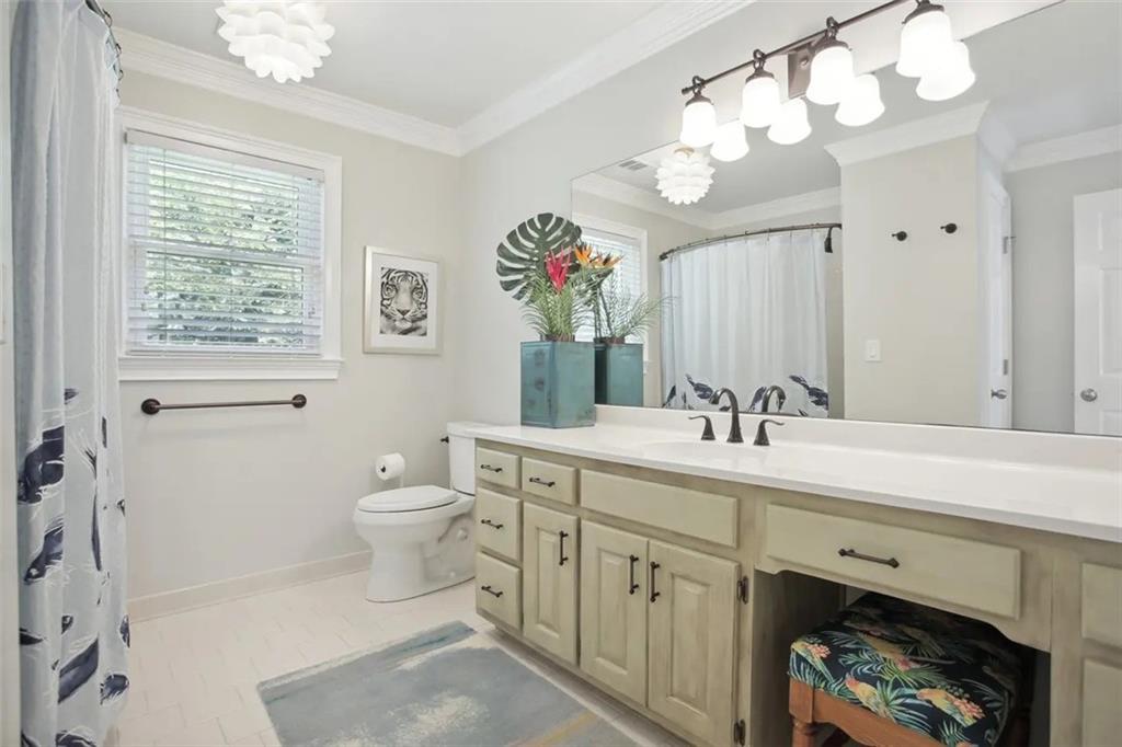 2672 Henderson Ridge Drive Tucker, GA 30084 - Photo 32 of 46 a spacious bathroom with a toilet a sink and a mirror