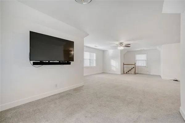 a view of a livingroom with furniture and a flat screen tv