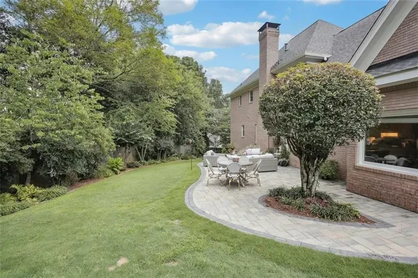 a view of a fountain in the backyard of house