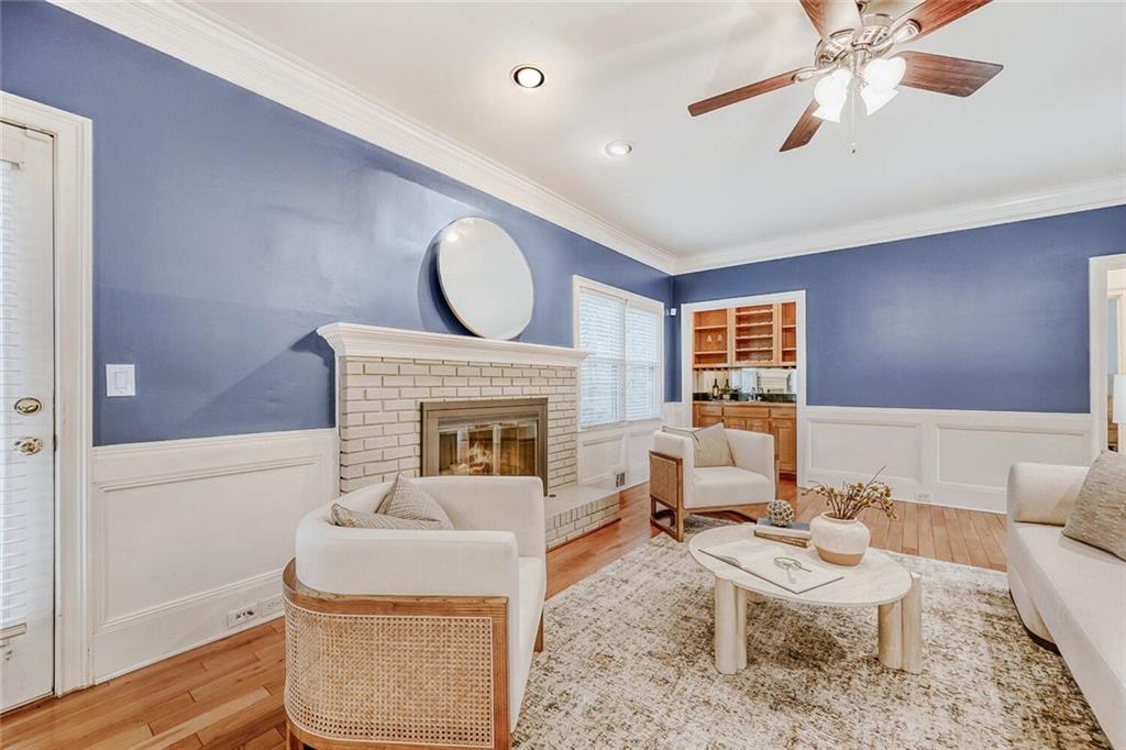2672 Henderson Ridge Drive Tucker, GA 30084 - Photo 7 of 46 a living room with furniture a fireplace and a ceiling fan