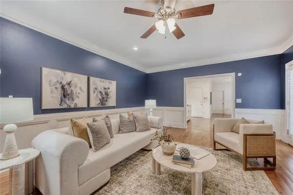 a living room with furniture a rug and a chandelier