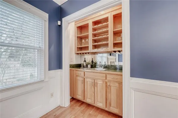 a kitchen with white cabinets and a window