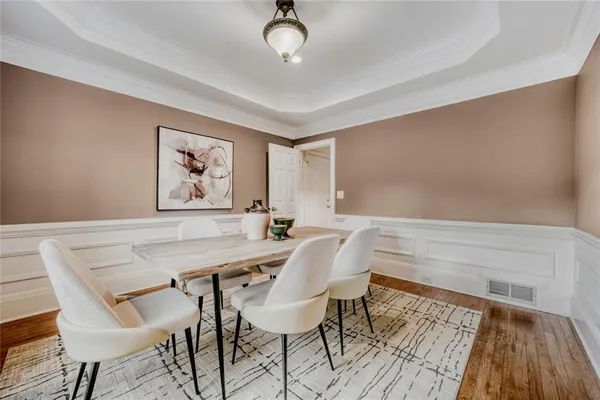 a view of a dining room with furniture and wooden floor