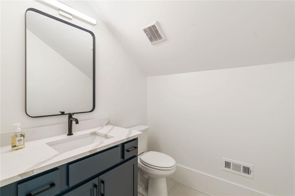 555 Lower Birmingham Road Canton, GA 30115 - Photo 84 of 104 a bathroom with a sink a toilet and mirror