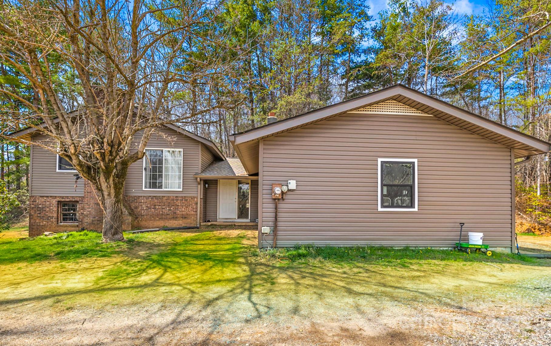 7923 Cruso Road Canton, NC 28716 - Photo 1 of 16 a front view of a house with a yard