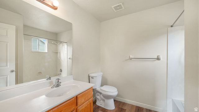 983 South 1850th Street West Springville, UT 84663 - Photo 11 of 30 Bathroom featuring a wood-finish vanity with an integrated sink, a large wall-mounted mirror, and a full bathtub with shower